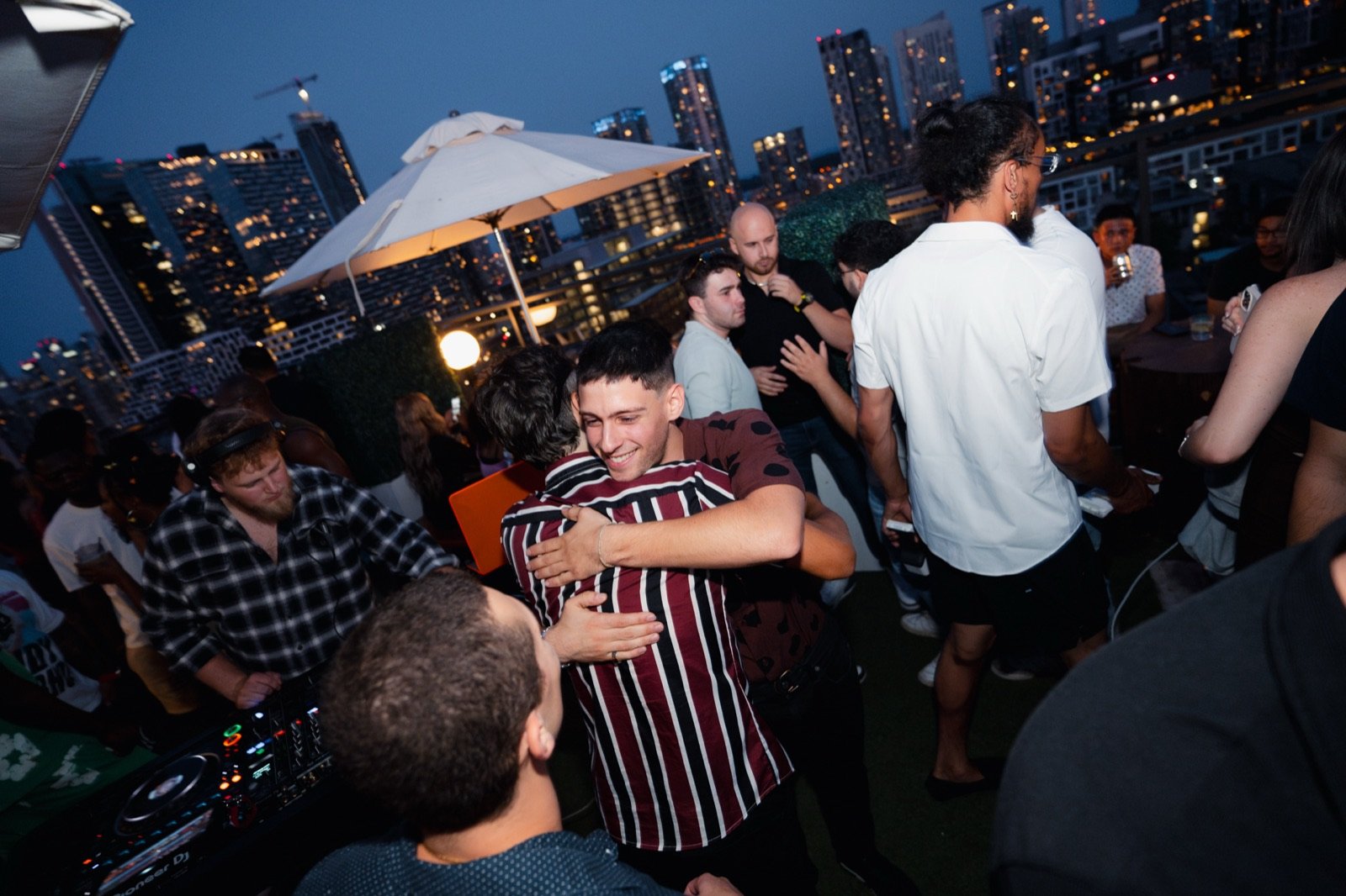 TALMOR getting a hug from a friend at the Lavelle rooftop